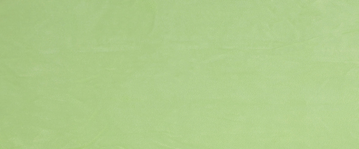 Fabric close up. A lime green shown in a neutral light.